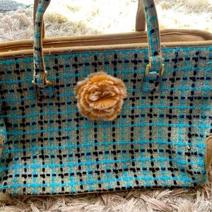 Trina fabric & leather tote bag that can hold a laptop. Pretty fur accent flower